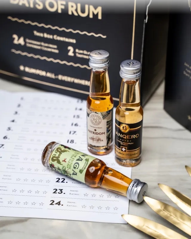 Two miniature bottles of rum next to the tasting sheet